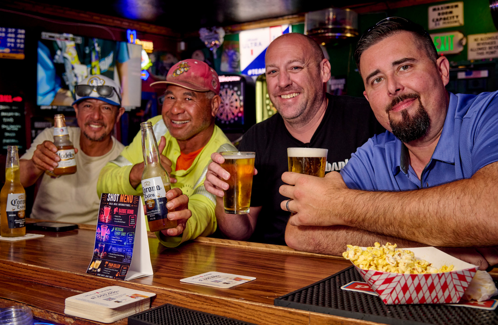 Regulars raising beers at the bar at Harvey's Sports Bar